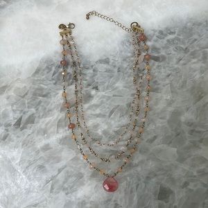 Peach colored 3 strand adjustable necklace. Gold tone